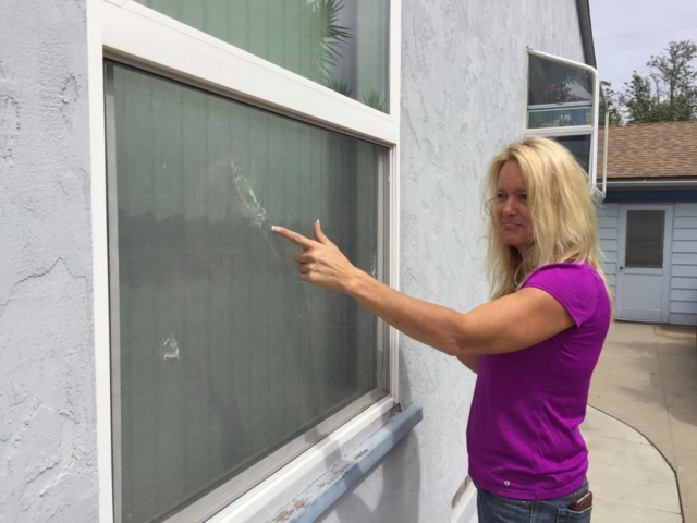 Connie pointing out window screen repair needs in San Diego